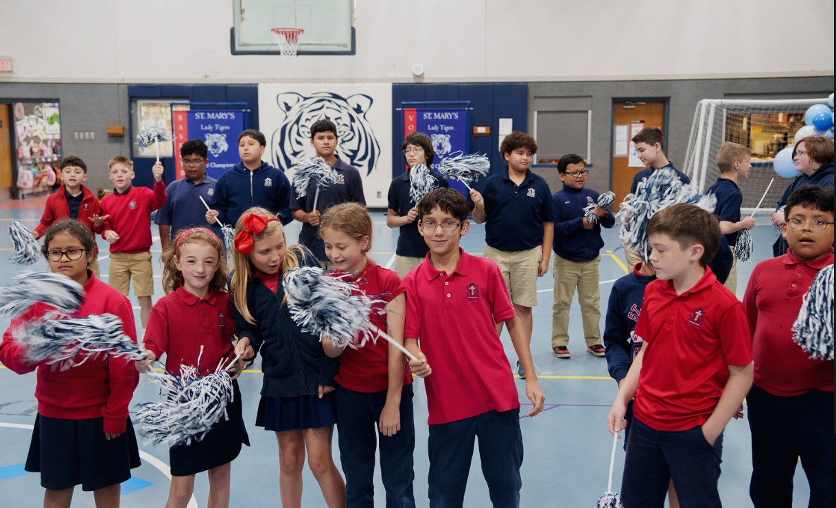 St. Mary's students waving pom-poms during a school pep rally