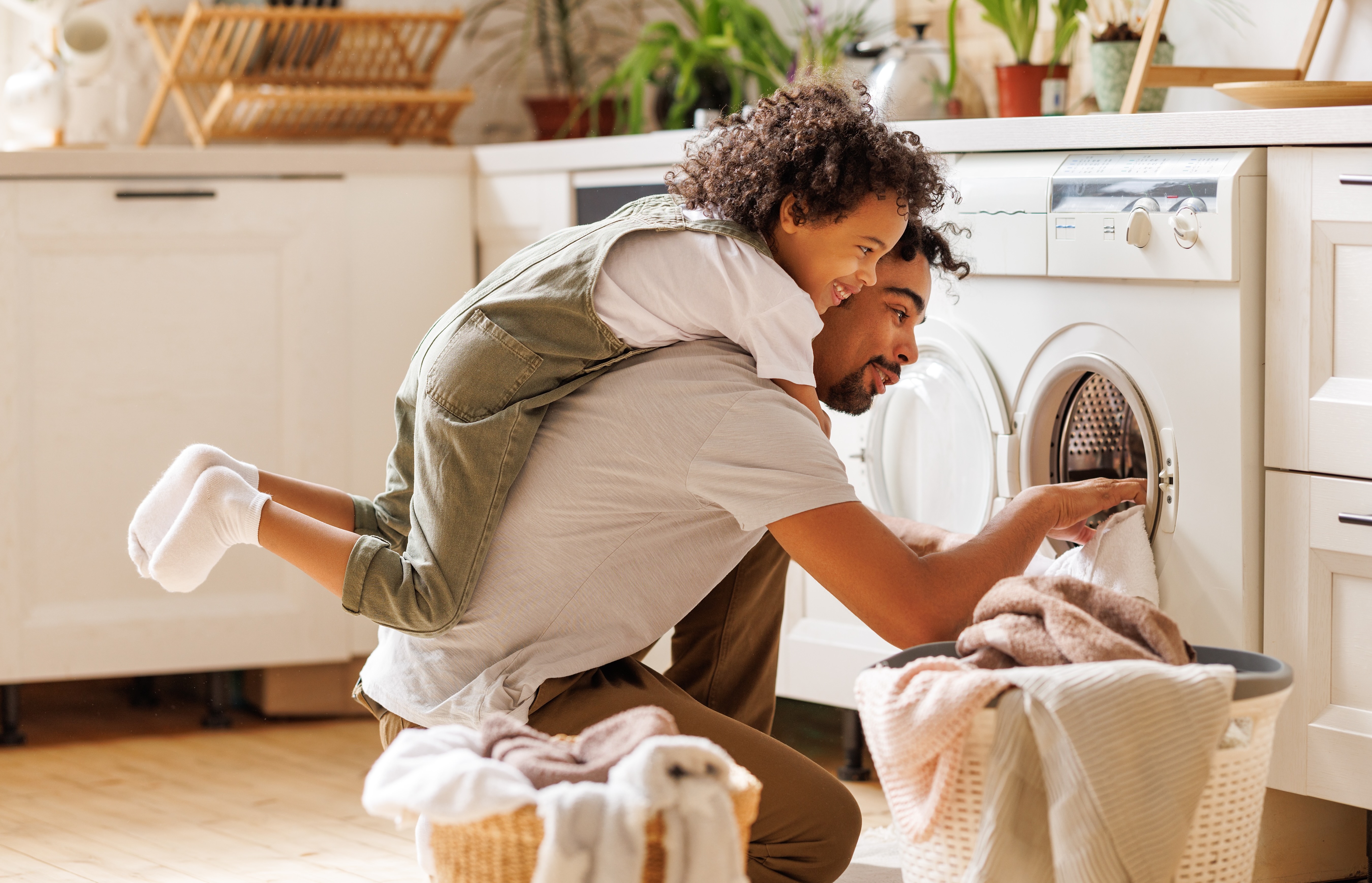 Dad and son doing laundry stock photo