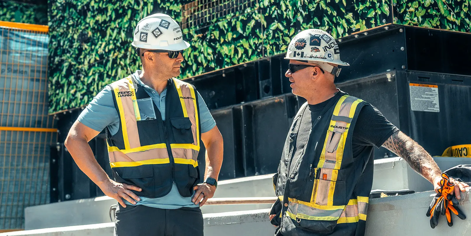 two men on construction site wearing PPE