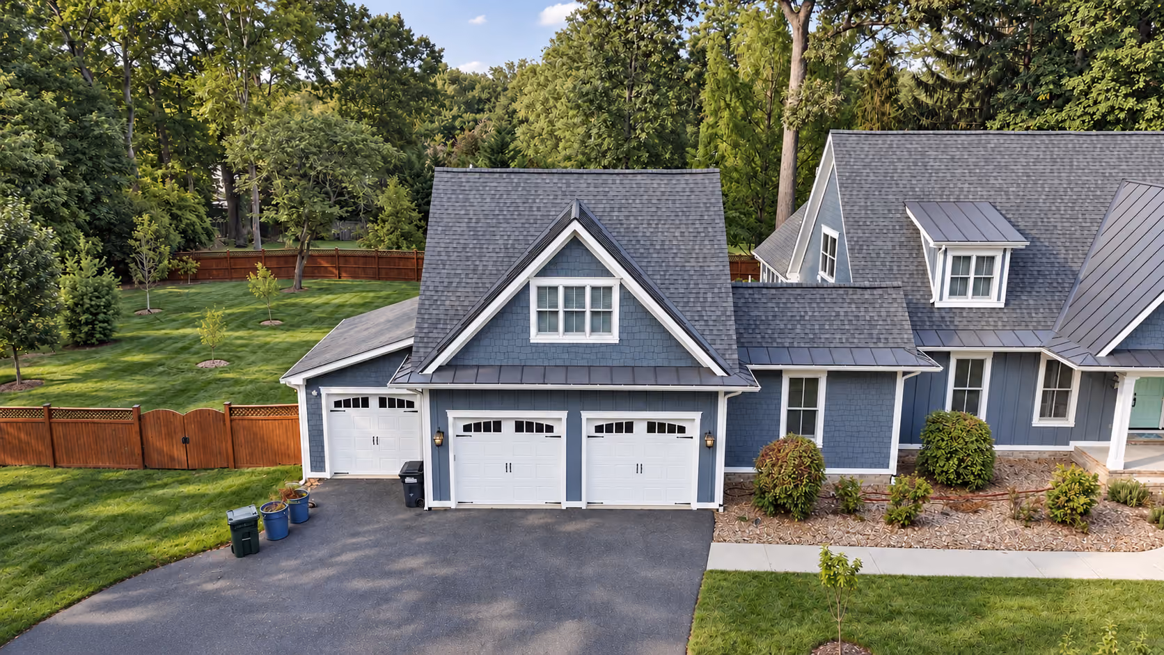 Attached garage apartment with blue siding and a three-car garage at 7500 Overlook Pl in Annandale, VA