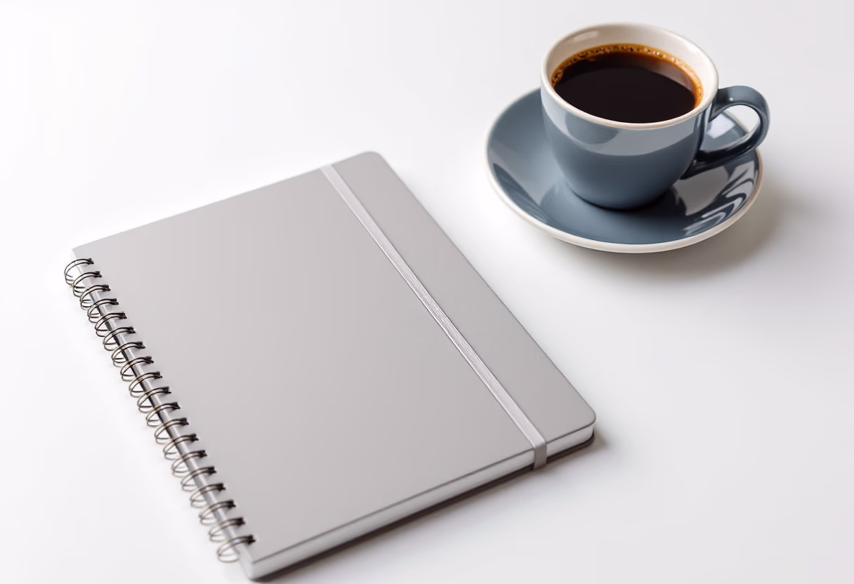 image of a notebook and a coffee cup on a desk (for a personal coach & consultant)
