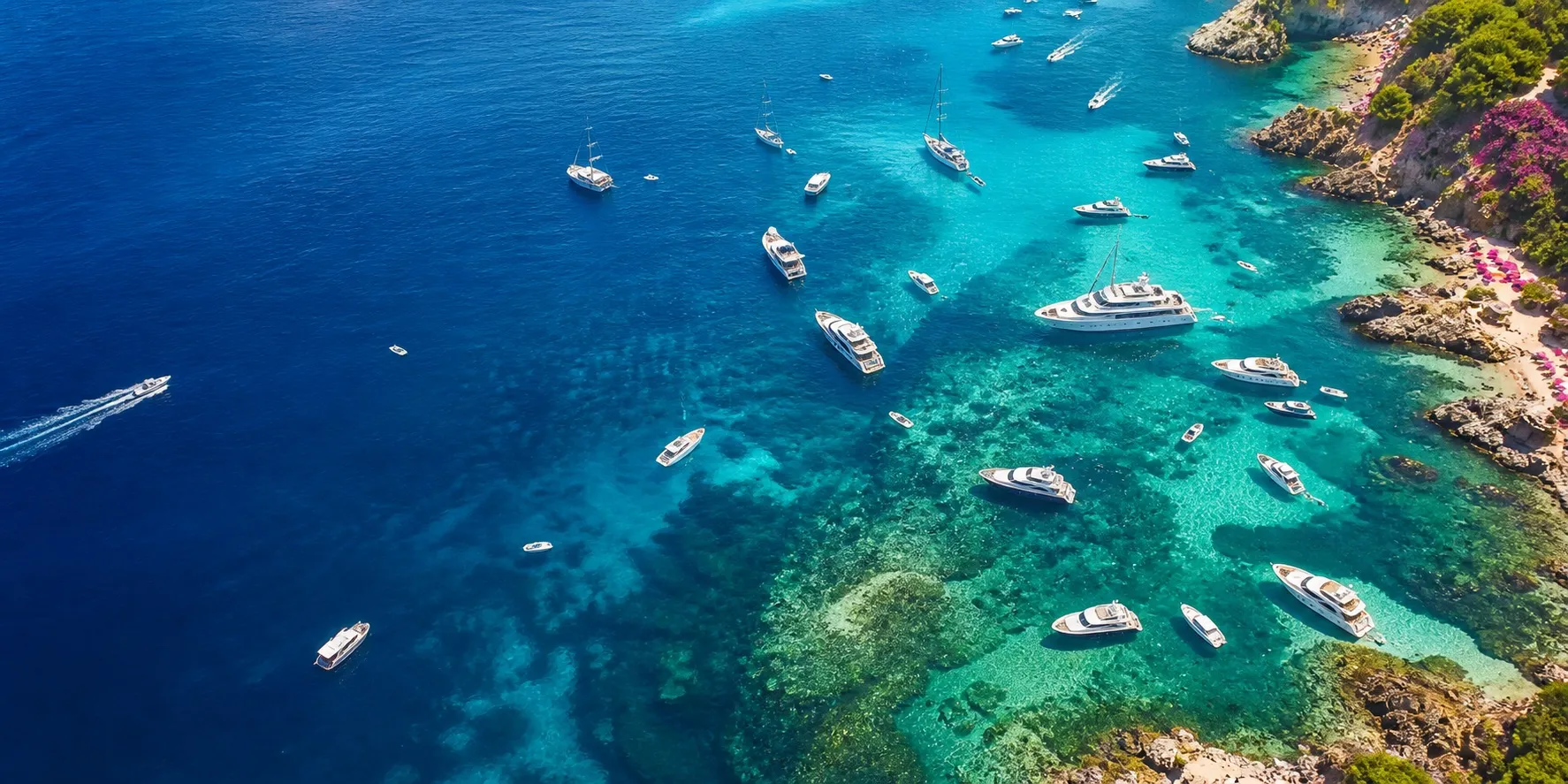 Aerial view of yachts anchored in crystal-clear turquoise water