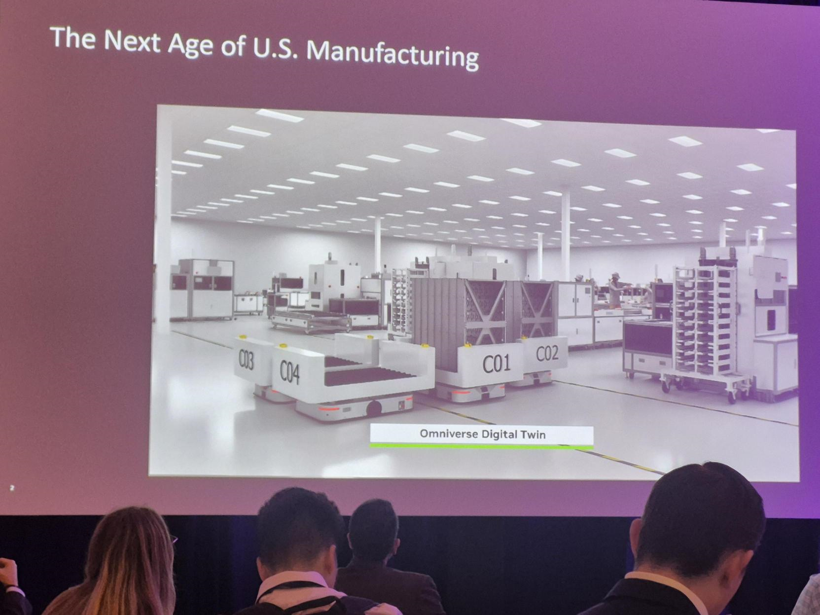 Conference slide titled “The Next Age of U.S. Manufacturing” showing Omniverse Digital Twin mobile robots.