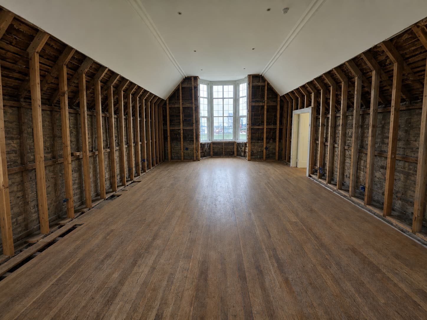 unfinished room with exposed insulation and bare walls
