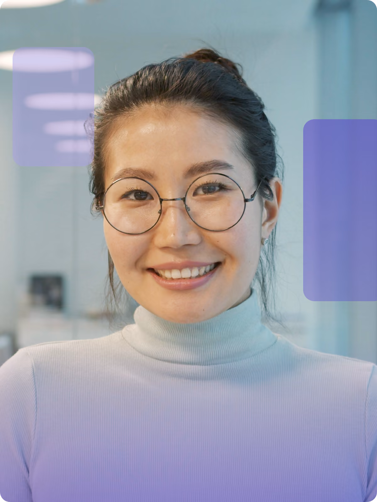 A smiling professional in round glasses and a turtleneck