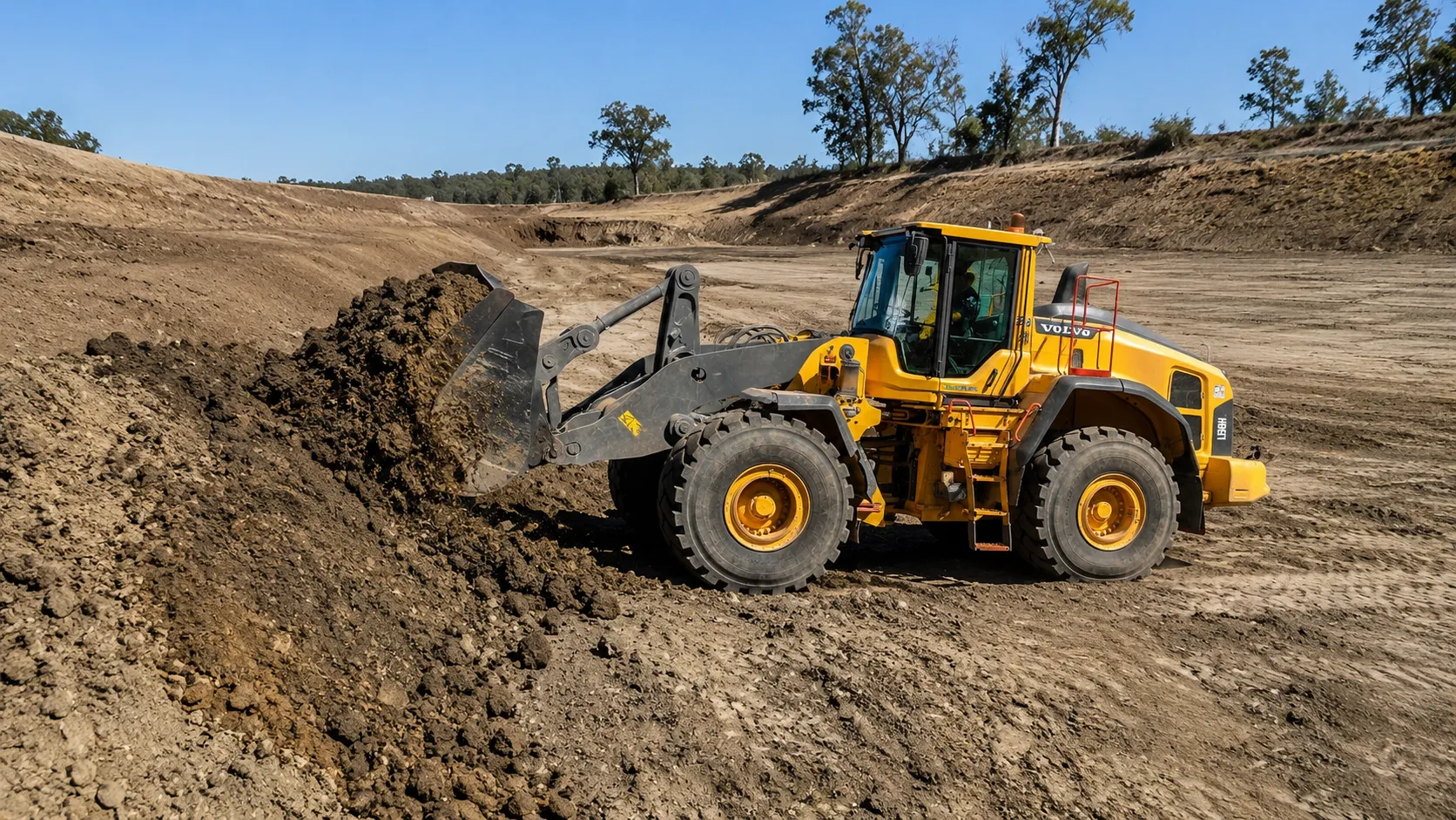 Volvo L150H earthmoving during dam work in rural Queensland.