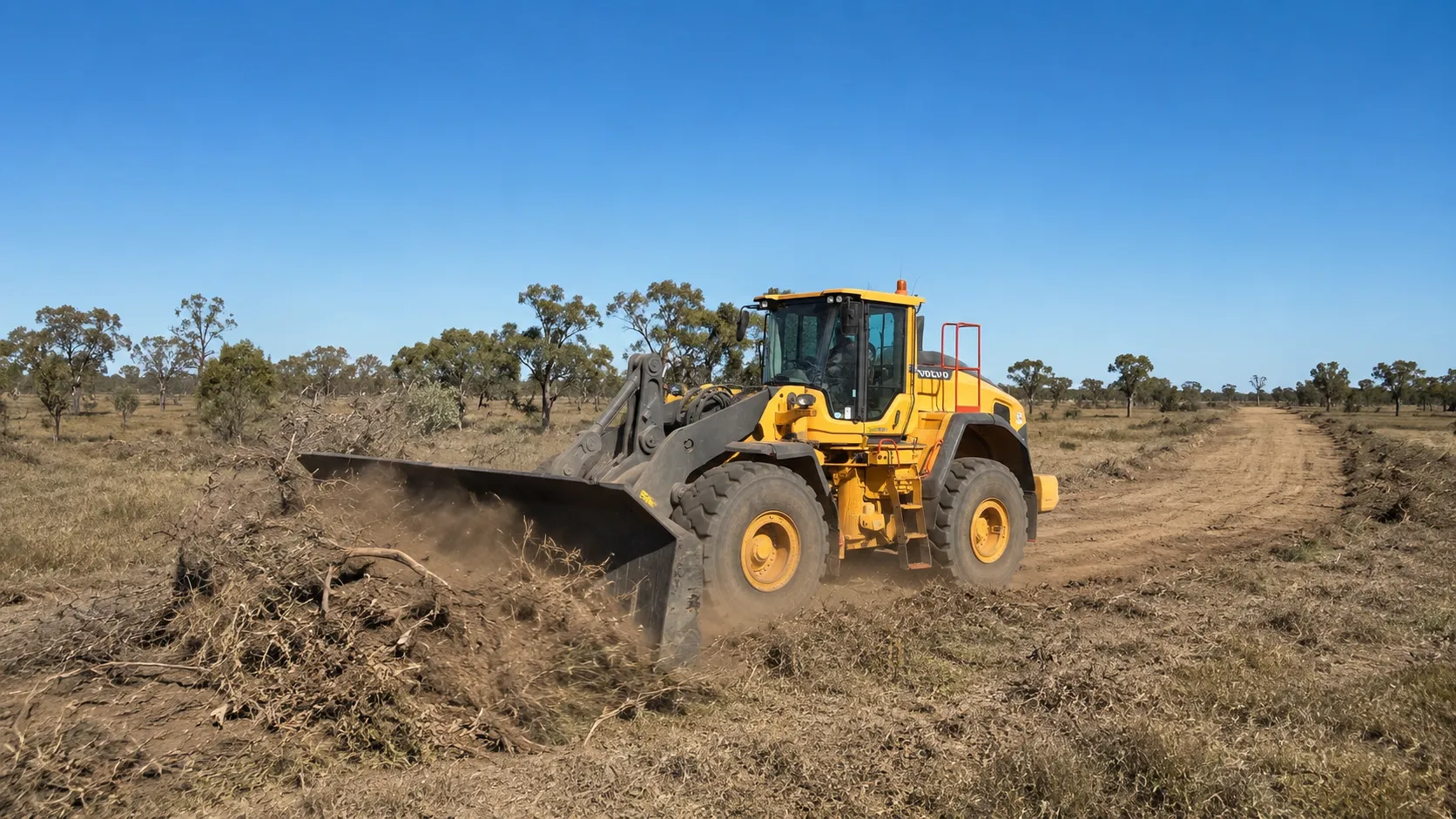 Volvo loader clearing a fire break in rural Queensland.