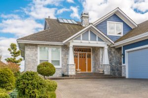 An outdoor view of a large home complete with windows and doors.