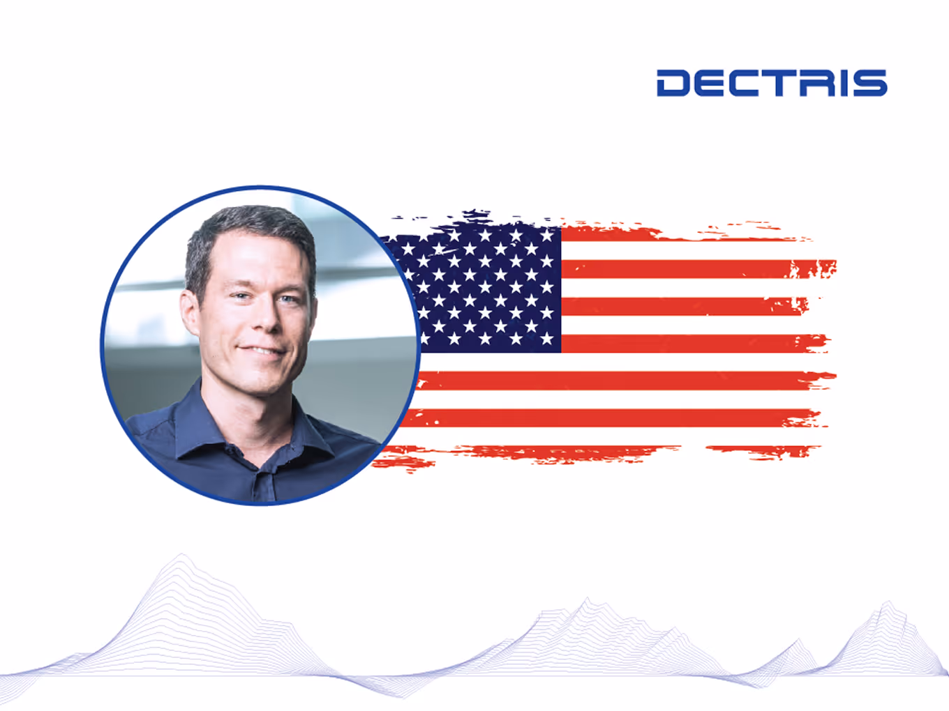 Portrait of a smiling man in a blue shirt inside a blue circle next to a stylized American flag and the text DECTRIS in blue.