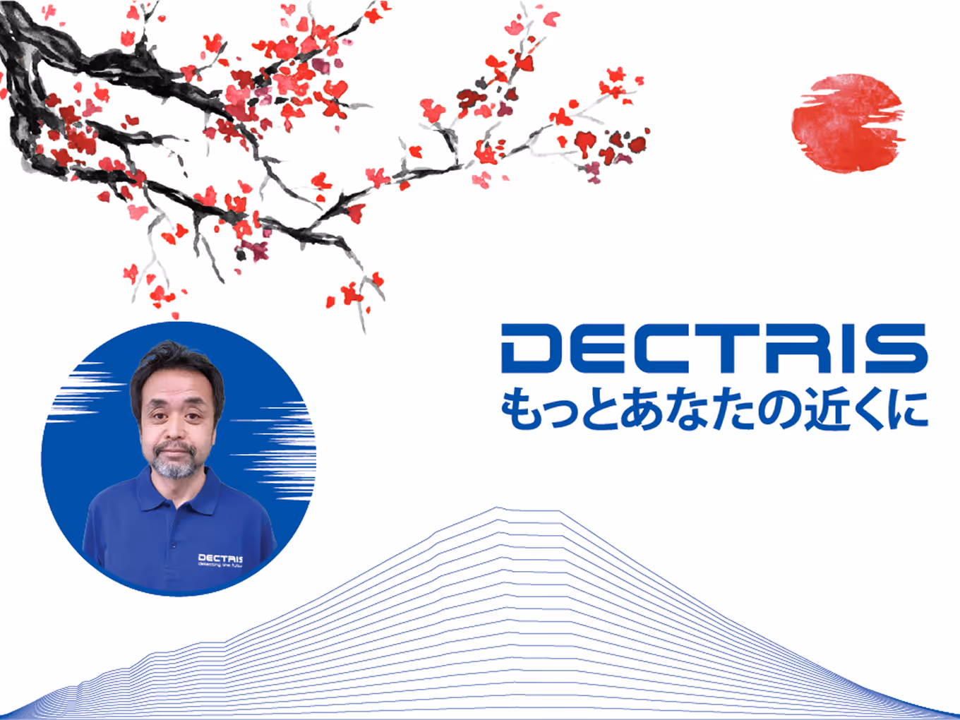 Man in a blue Dectris polo shirt with a stylized red sun and cherry blossom branch artwork above.