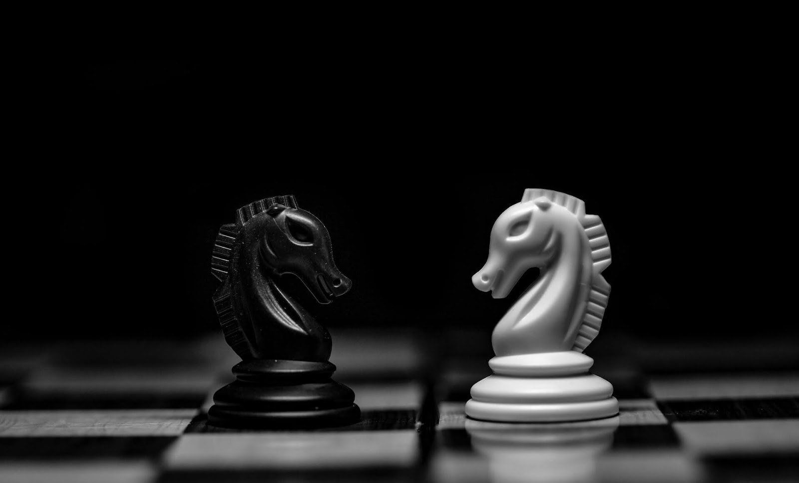 two knights face-to-face on a black and white chess board to represent two-way communication