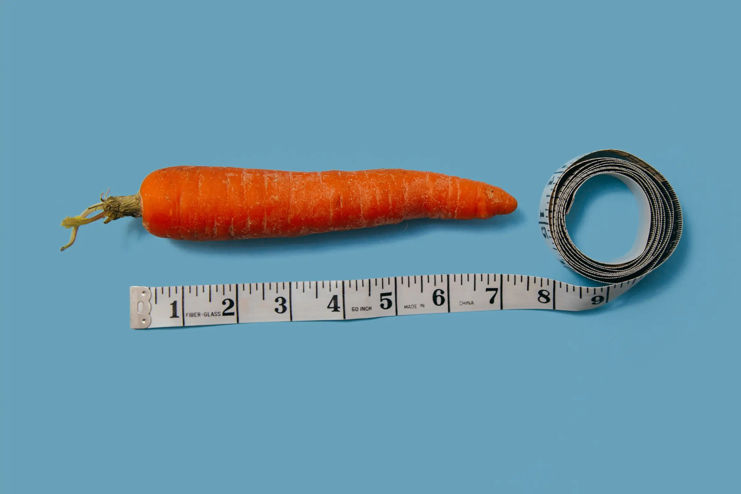 Measuring tape alongside a carrot to represent the importance of tracking results in category management.
