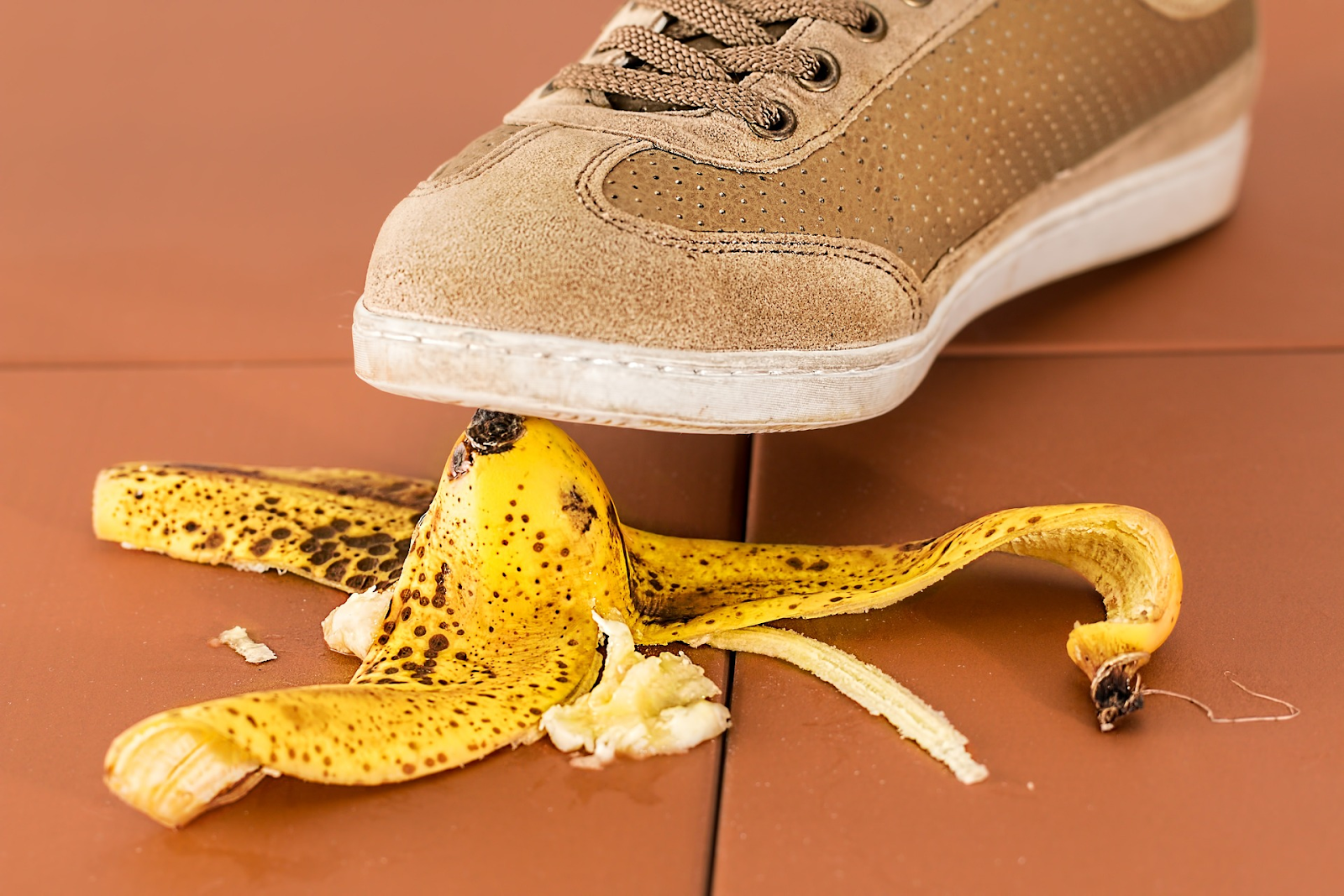 A foot about to step on a banana peel to symbolize the consequences of delivering a negative procurement experience.