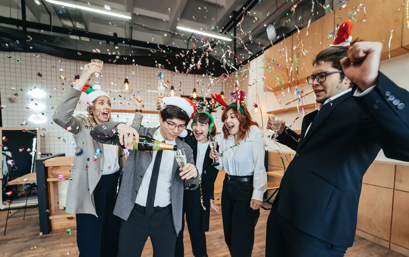 Office workers celebrating to represent the rewards of maintaining healthy supplier relationships as part of effective risk management in procurement