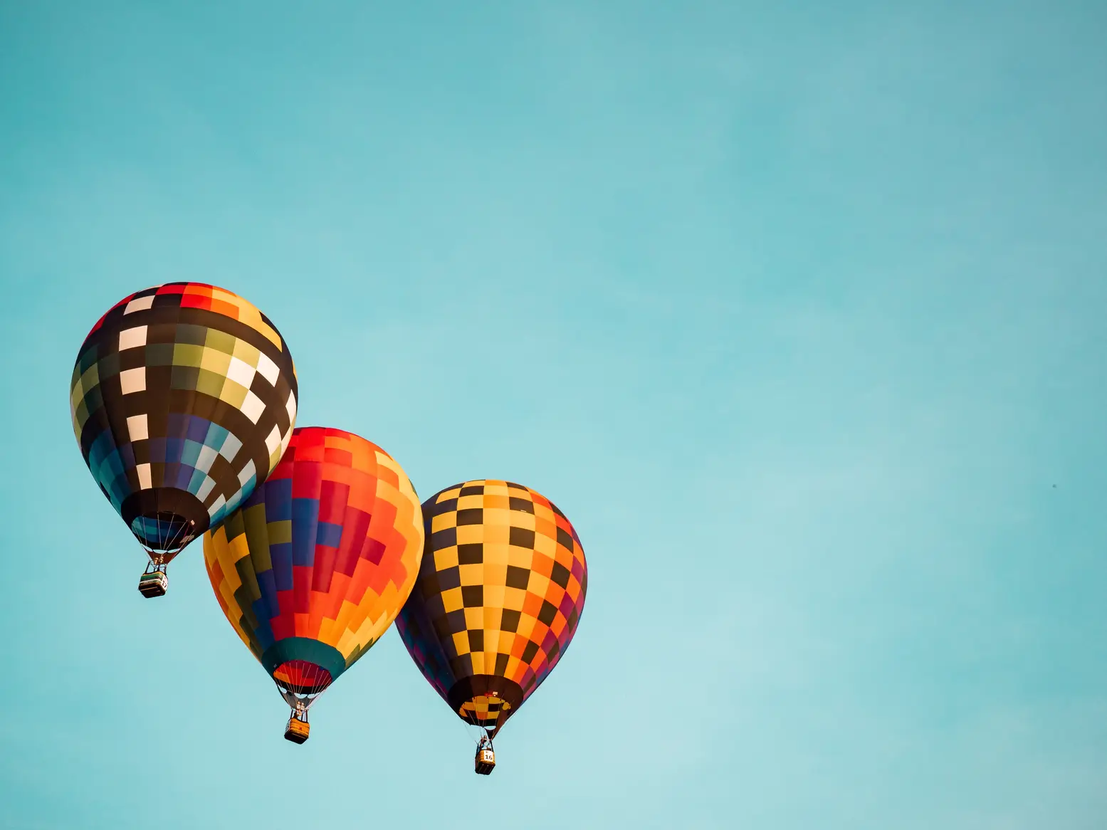 Three hot air balloons together to represent three-way matching in procurement.