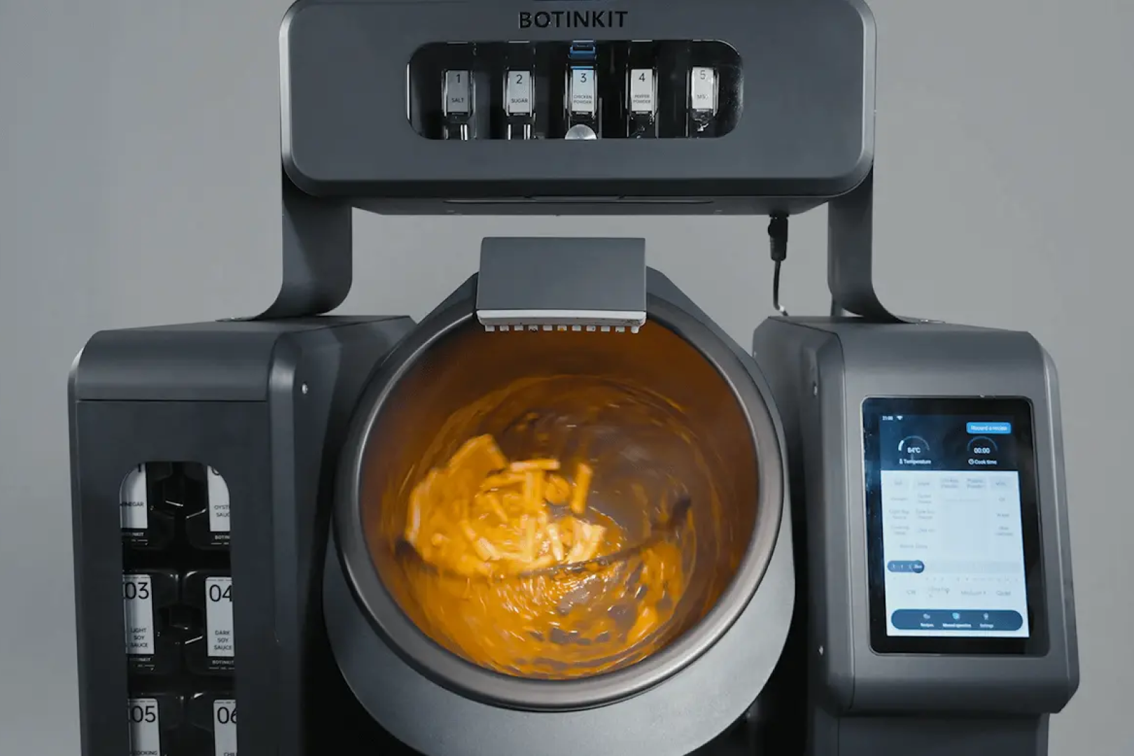 BotInKit Omni seasoning dispensers above the wok