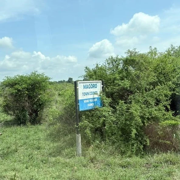Magoro Town Council roadside sign in a green rural landscape on the Uganda mission trip.