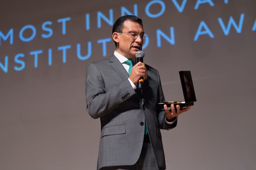 Speaker holding an award at the Medical Intelligence Summit