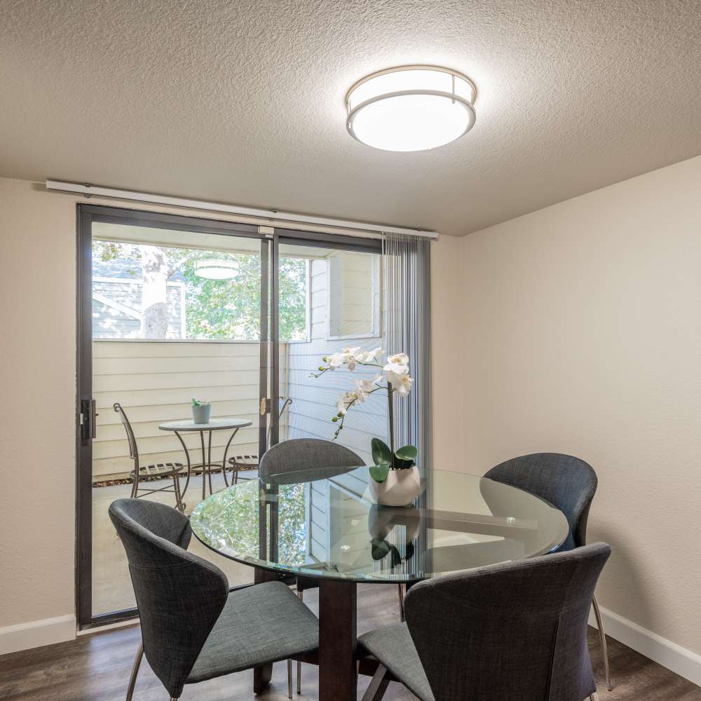 Dining area with table and chairs and view of balcony
