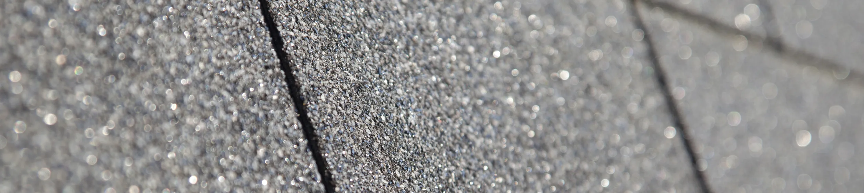 Close-up view of gray asphalt roof shingles.
