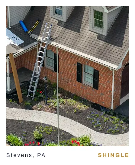 Edge View roofing team working on a shingle roof on a house in Stevens, PA
