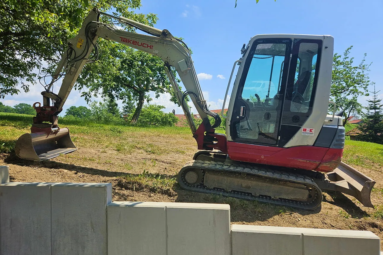 Minibagger bei Erdarbeiten auf einer Baustelle.