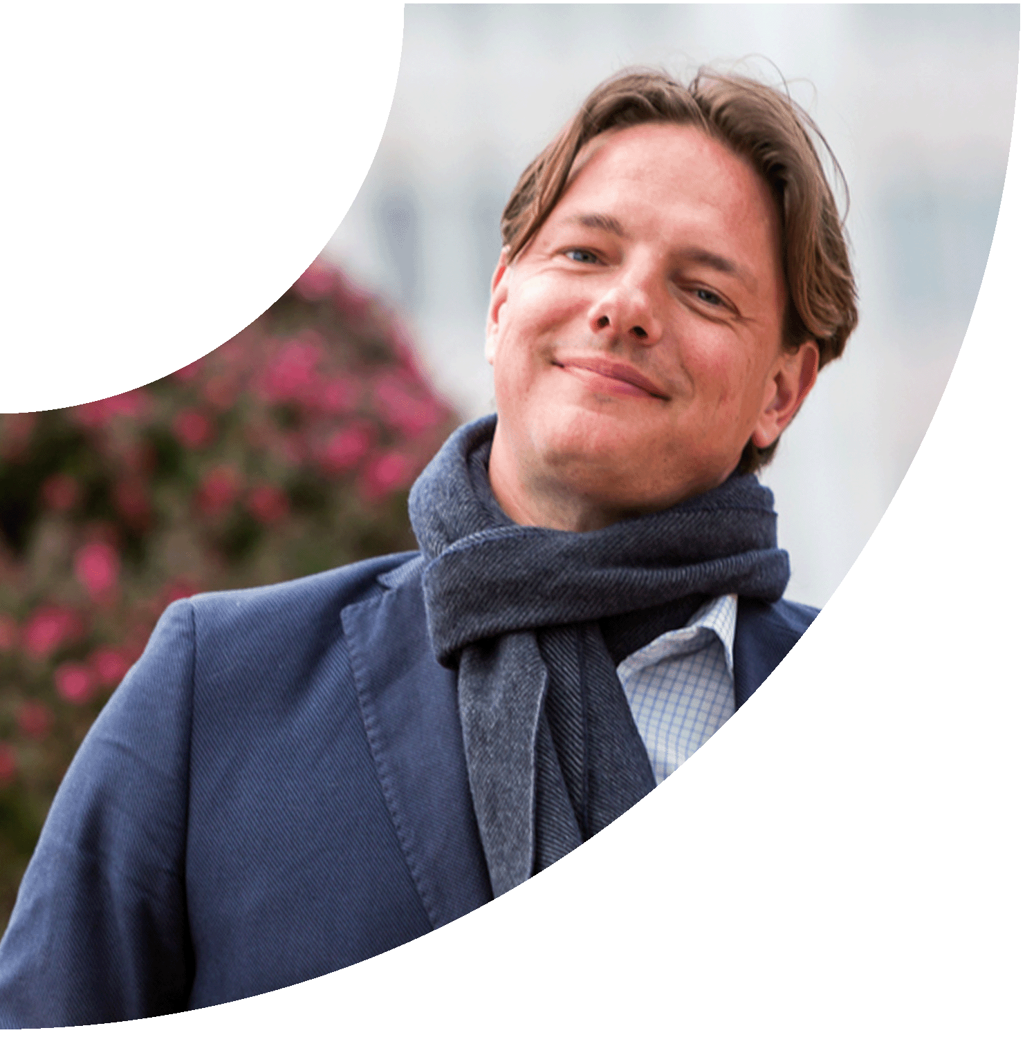 Smiling IPG member in a navy jacket and scarf