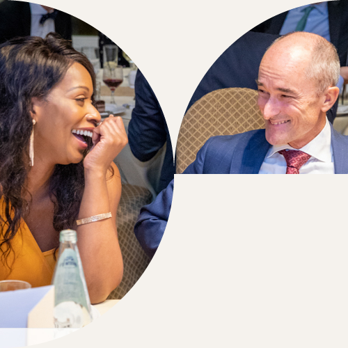 IPG members laughing together over dinner at an IPG conference