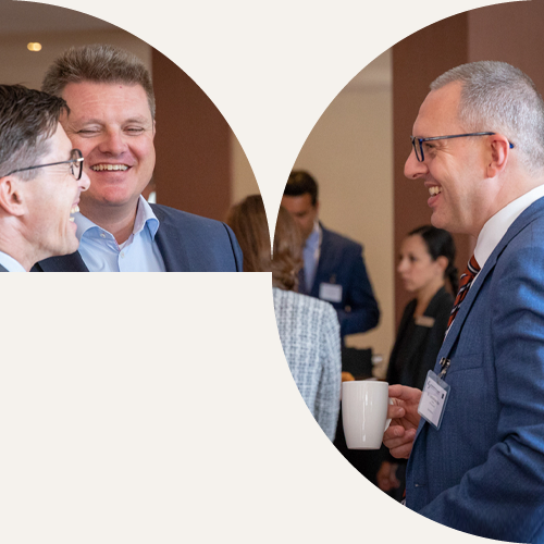 IPG members chatting and laughing over coffee during a conference break