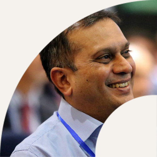 Smiling IPG member wearing a conference lanyard