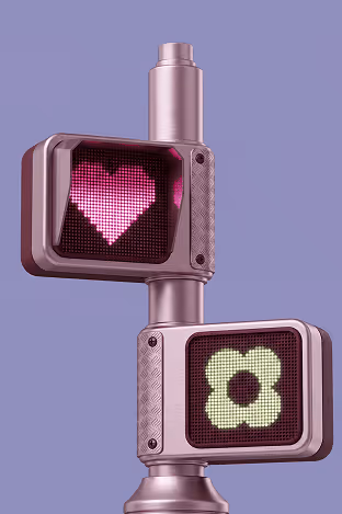 Traffic light showing a pink heart symbol and a white flower shape on purple background.