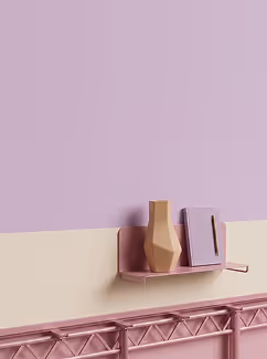 Minimalist pink shelf on pink and beige wall holding a modern beige vase and closed book.