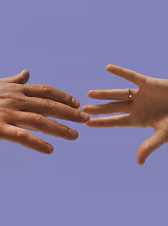 Two hands reaching toward each other against a purple background, one with a ring on the finger.