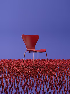 Red chair with metal legs on a dense red textured surface against a plain blue background.
