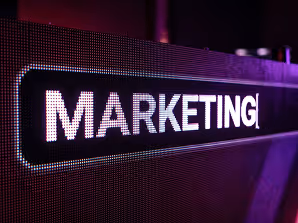 LED screen displaying the word MARKETING in white letters with purple lighting.