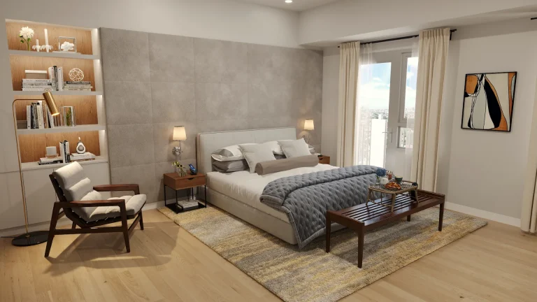 Modern bedroom with a bed, gray quilt, wooden bench, armchair, built-in shelves, and balcony doors.