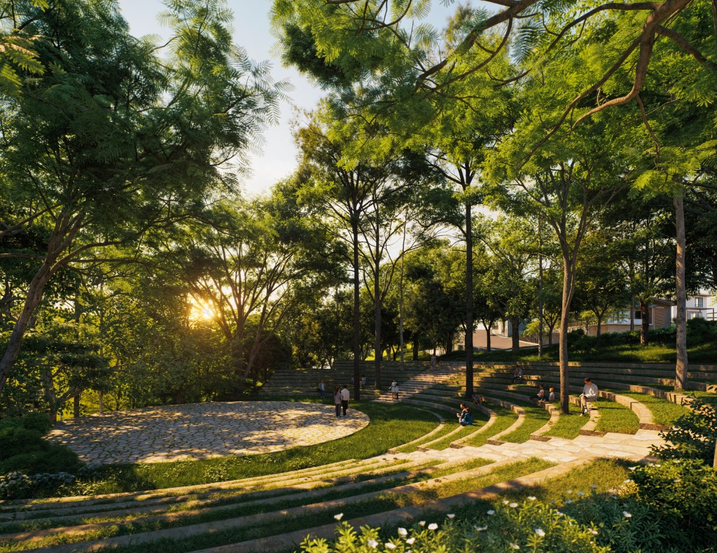 Outdoor amphitheater with stone seating and people scattered under leafy trees at sunset.
