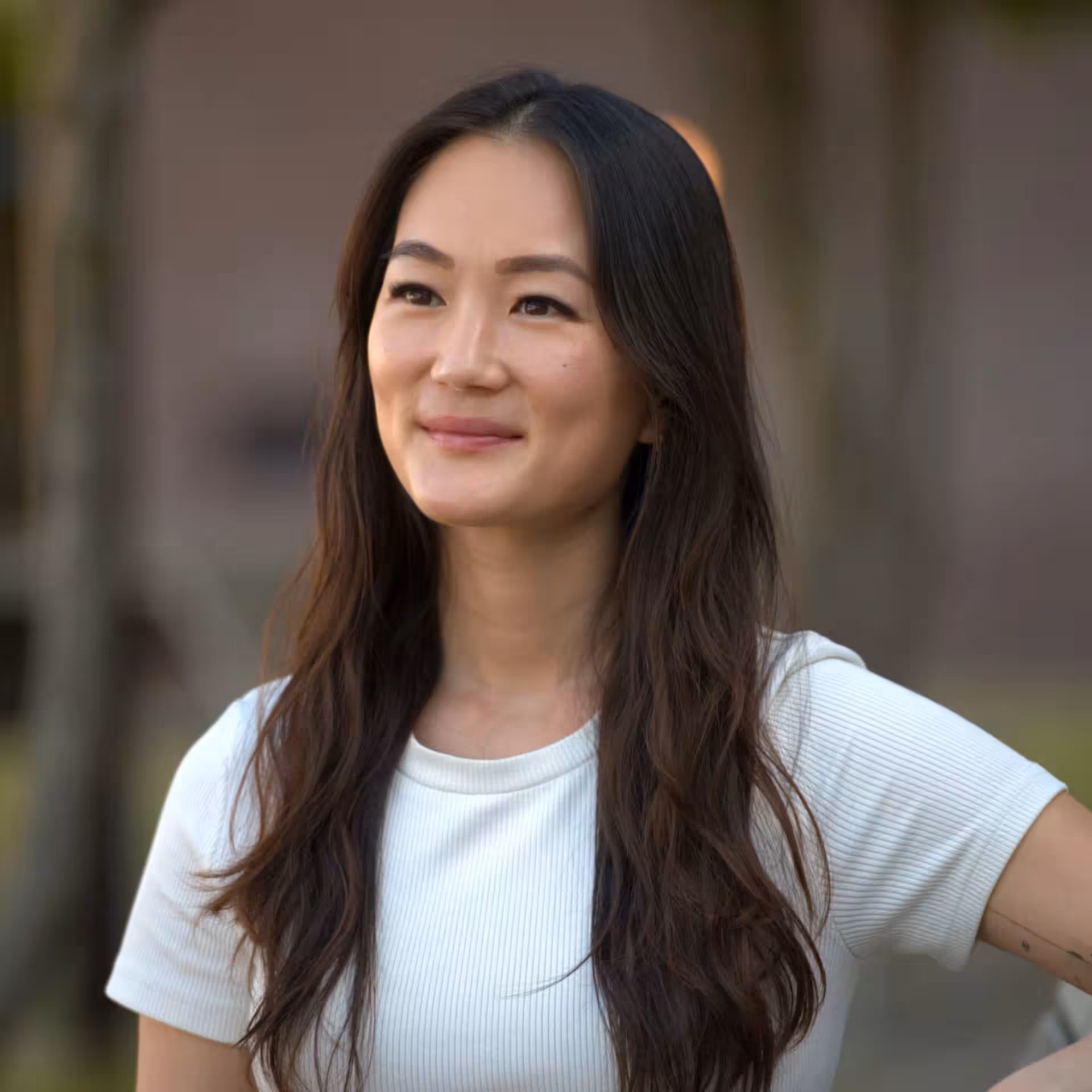 Helena, founder of mindfulbuilders, portrait photo in white t-shirt with natural light and calm expression.