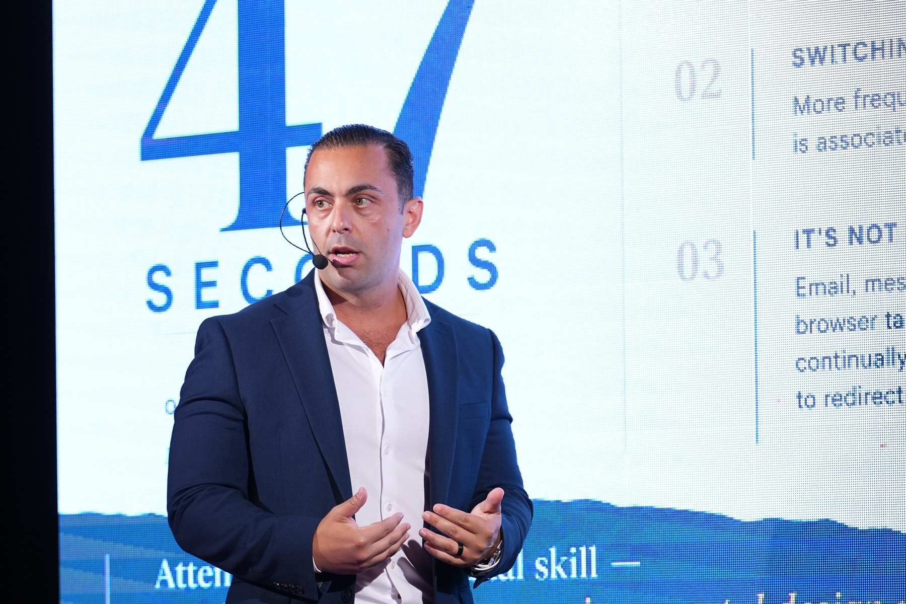Dr. Tamir Aldad delivering his keynote on the hidden cost of interruption