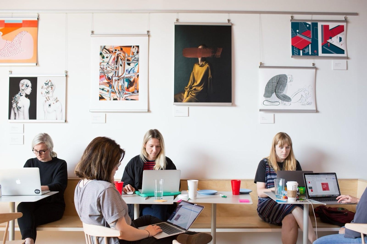 The Format Team working at several tables.