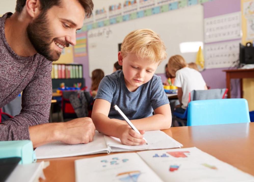 A teacher helping a student in the classroom.