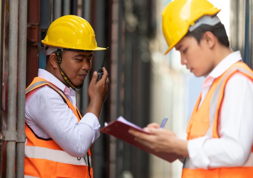 Two construction workers working on a new project.