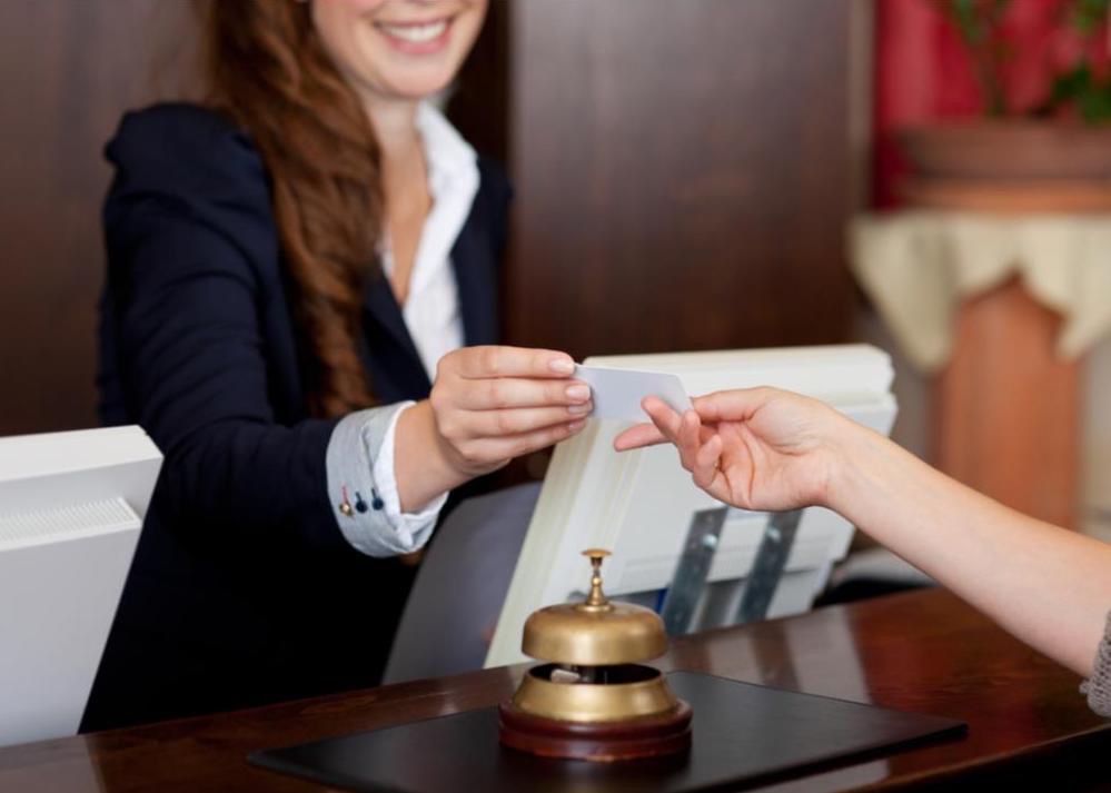 Hotel concierge checking someone into their room.