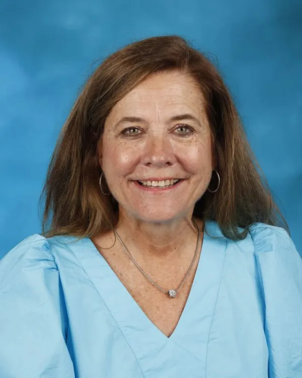 Sandy Buckner smiling in a professional school staff portrait