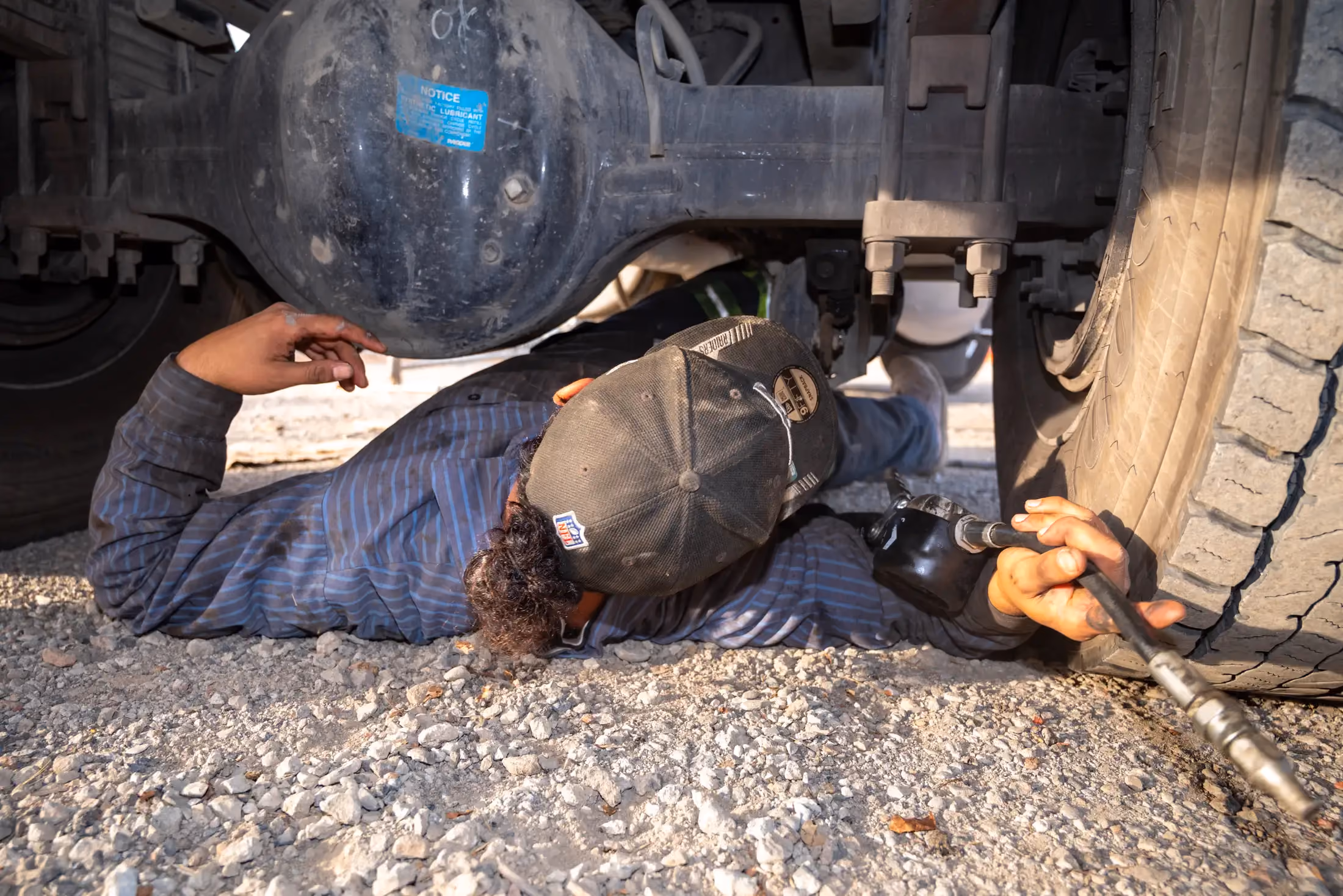 Mechanic performing truck axle repair