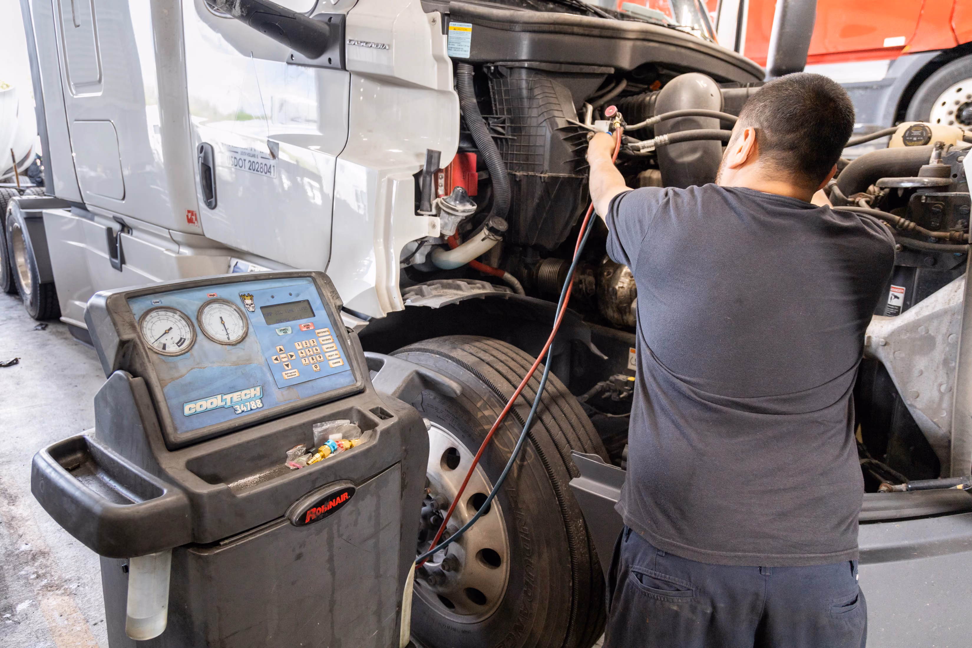 Diesel mechanic performing HVAC system repair