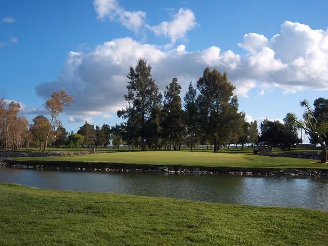 Tree-lined fairway and green at Davis Golf Course in Yolo County
