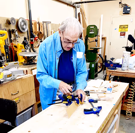 Woodworker assembling a wooden box in the PVE Termites workshop