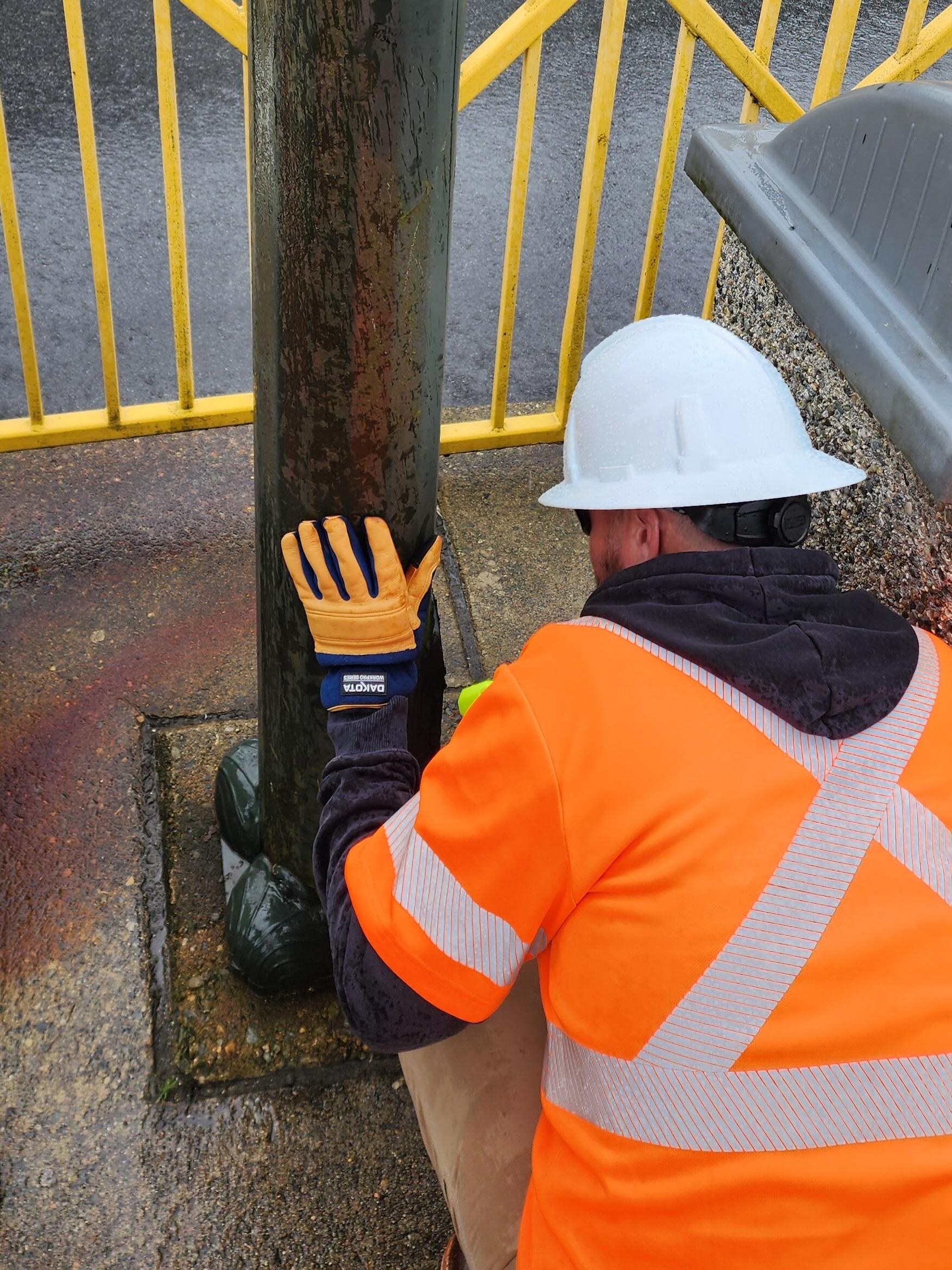 Streetlight pole review for defects, access, and safety.