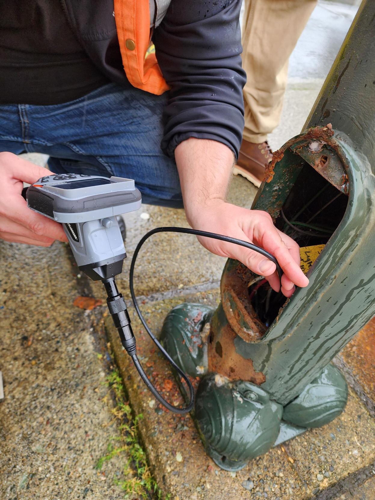 Streetlight pole review for defects, access, and safety.